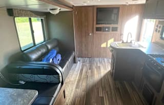 Camper with a queen living space and a bunkhouse.