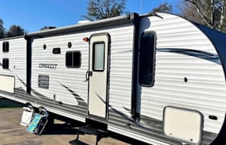 Camper with a queen living space and a bunkhouse.