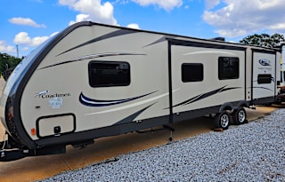 Large RV with outdoor kitchen, fireplace, and TVs