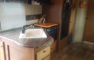 Pet Friendly RV Rental w/outdoor kitchen with stove, grill, fridge, sink. Sleeps 4-6.