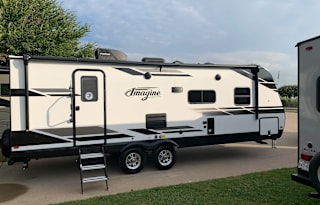 Kayaks, paddle boards, and camper.