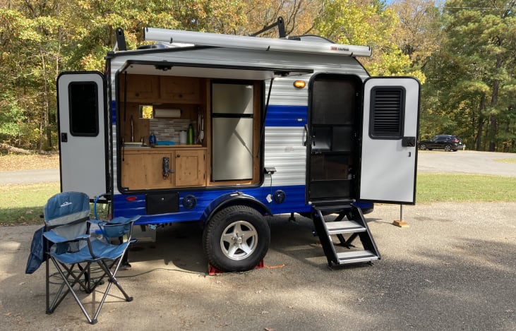 Outdoors kitchen with spacious refrigerator and freezer.