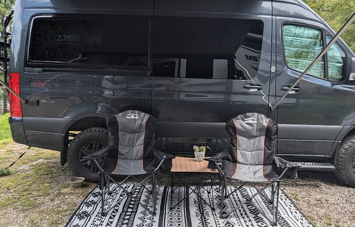 Outdoor rug, chairs, and table included for under the awning to enjoy relaxing outdoors.