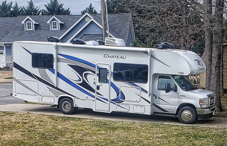 White exterior with blue highlights. 14 ft awning, Ford E-450