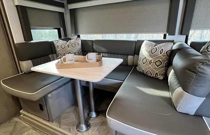 Spacious dinette table with U-shaped seating arrangement. Dinette are converts in to bed.