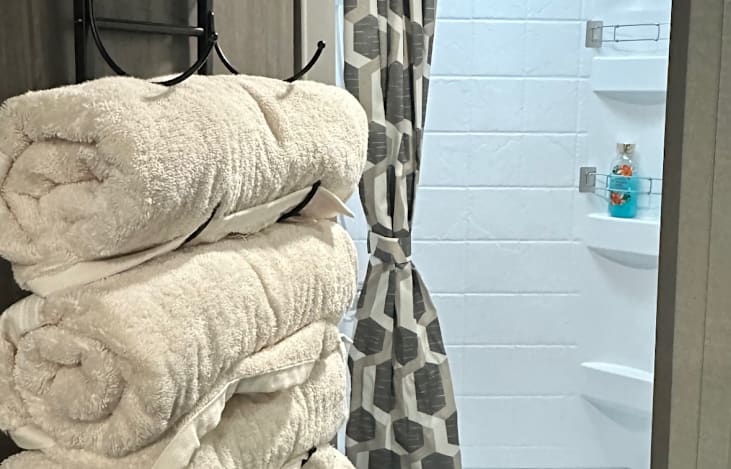 Full bathroom with shower, toilet and sink. 
Stocked with towels, body wash, shampoo and conditioner.