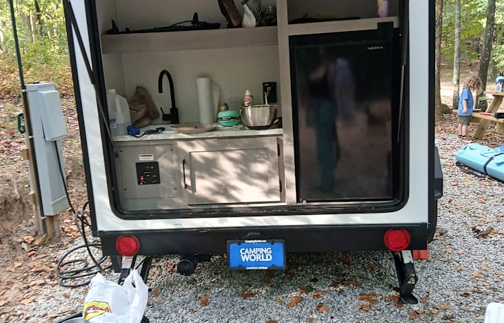 Outdoor kitchen with sink, outlets, fridge, storage
Flat top griddle mounts to right

Water and electric hookups to left