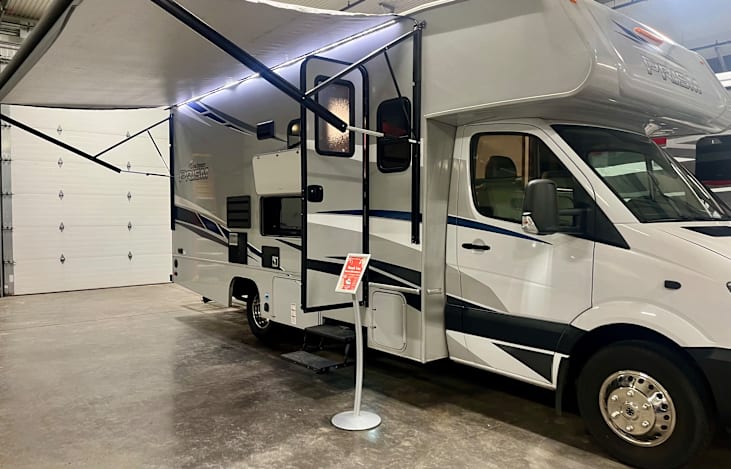 Passenger's side with outdoor entertainment center, awning, and hook up for propane grill or Blackstone