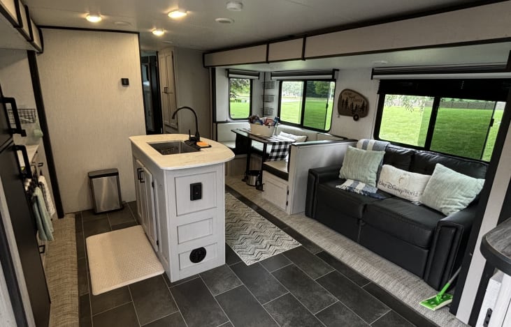 Farm style sink with kitchen Island. Sofa pulls out to a full size bed. Kitchen table converts to a bed as well.