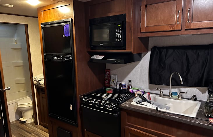 Full gas stove and oven with microwave and a very good refrigerator