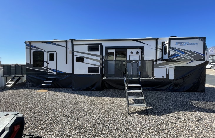 5th Wheel Toy Hauler with side and rear patios accessible from inside and outside the RV.