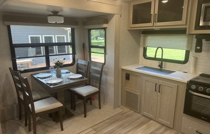 Kitchen with gas stove, oven and microwave. Extra large refrigerator with bottom freezer. Pantry and table for four.