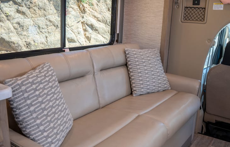 Jack-knife sofa features 2 seatbelts and easily converts into a full sized bed!