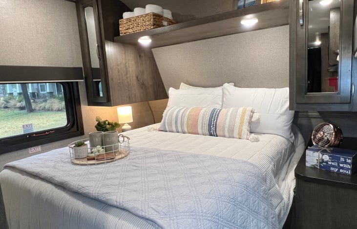 The primary bedroom features an upgraded 10" Doze memory foam mattress and is private & conveniently located in the front of the RV. (Bedding not included in the rental.)