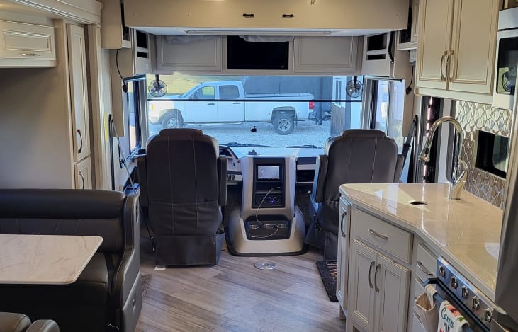 View from the recliners. The loft bed drops down above the cab area