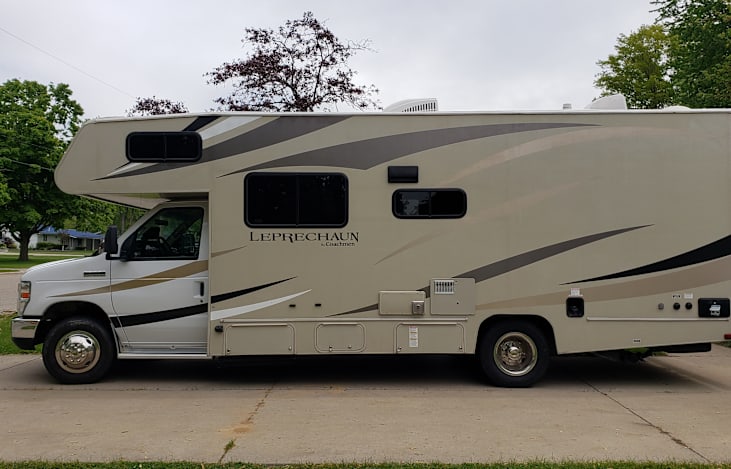 The floor plan of our Leprechaun is a 230 CB with customizations. It is similar to the floor plan shown, except the large dinette has been replaced by two comfy recliners, and both beds are queens.