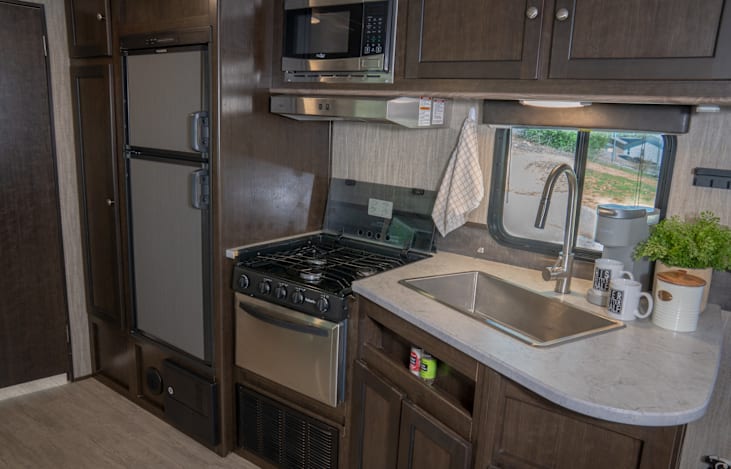 Fully stocked kitchen includes single serve Keurig machine, coffee pods, creamer, and sugars.  Includes all cookware, serve ware, washable and paper/plastic products.