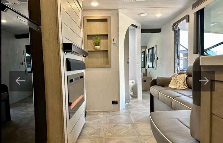 View from kitchen towards the door and back of the RV. The hidden bunk room is to the left