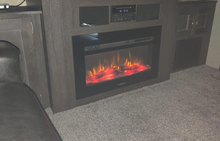The ambiance of the electronic fireplace makes for a cozy atmosphere.