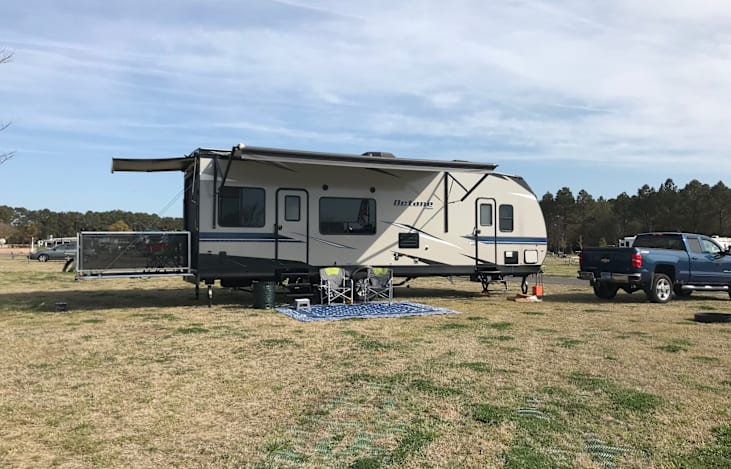 Profile from right side of RV, with back porch set up with porch awning.