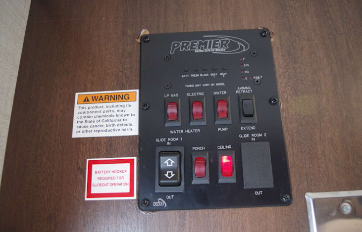 Control panel for lights, water pump, hot water selection- gas/electric. 12V outlet added next to control panel for ease of phone charging.