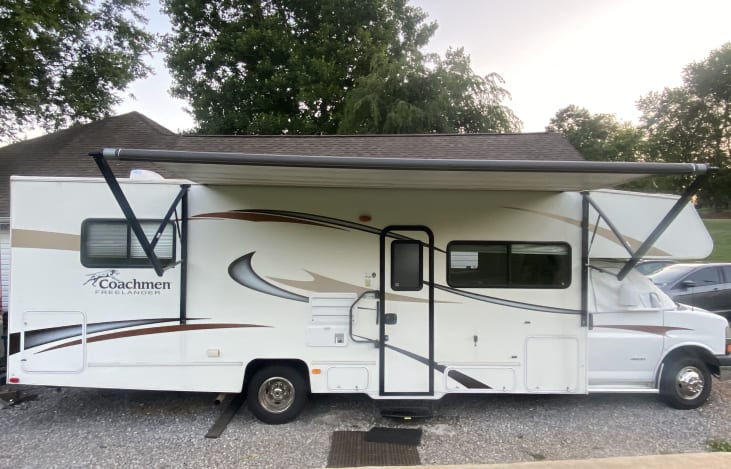 Beautiful RV with a big wonderful awning ready for your family adventures.