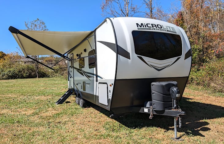 Fun little camper with outdoor griddle and large awning!