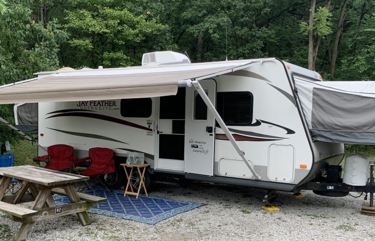 Front of camper, we supply a nice rug for outside the camper as well as a few camping chairs, we also have all the campfire necessities you need to cook great campfire food and desserts.