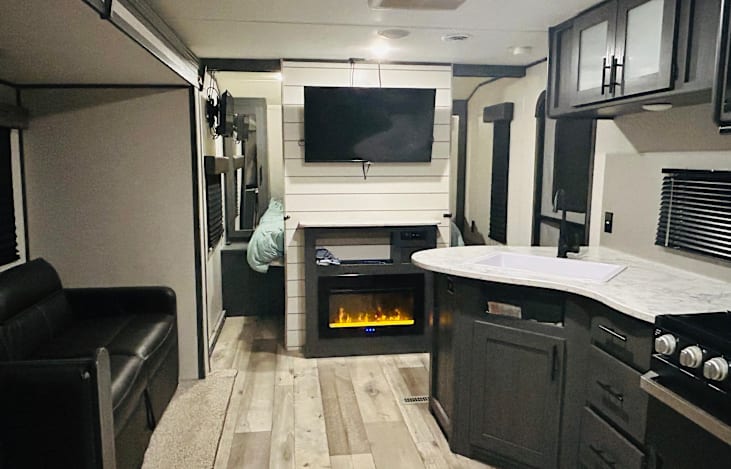 Living Area: 40 inch TV, radio, fireplace, 2
Seater couch, dinning table.