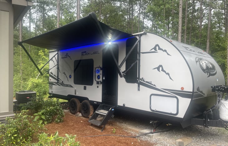 Electric Awning, outside speakers with outside TV Mount.
