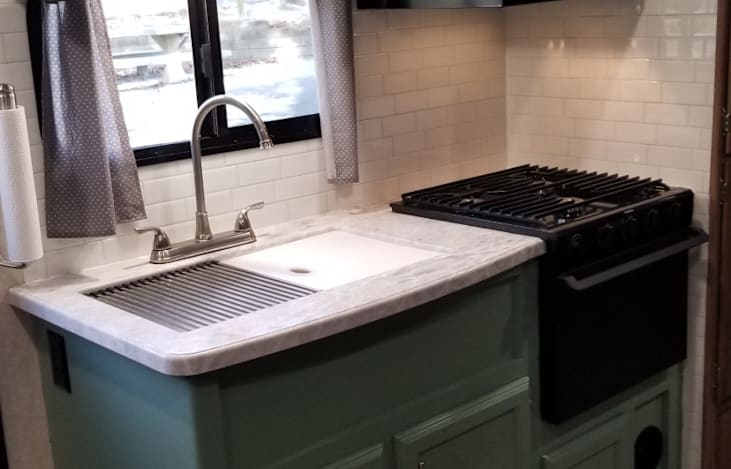 Modern kitchen on the move! 🧑‍🍳 Enjoy a deep sink, 3-burner stove, microwave, spacious counters, and tons of storage—all in a beautifully updated space that feels just like home.