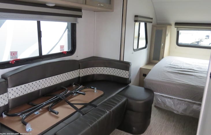Queen size bed and storage on the sides of bed.