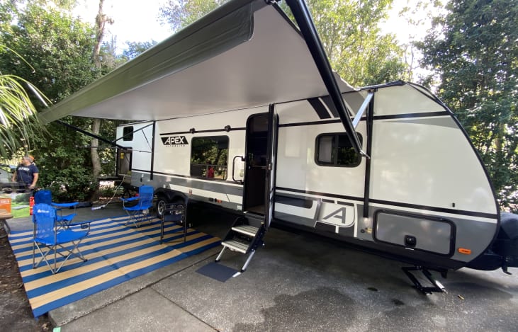 Retractable Awning with led "mood" lighting. Outdoor mat, chairs and table included