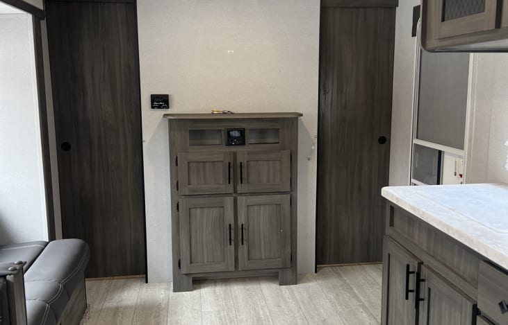 Living area. Private queen bed behind sliding doors