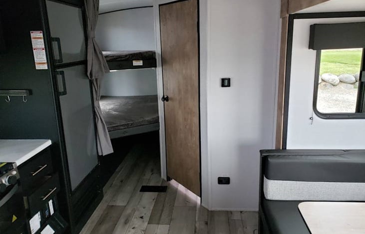 Interior Middle facing back with bathroom on the right thru door. Bump out with table also sleeps 2.
