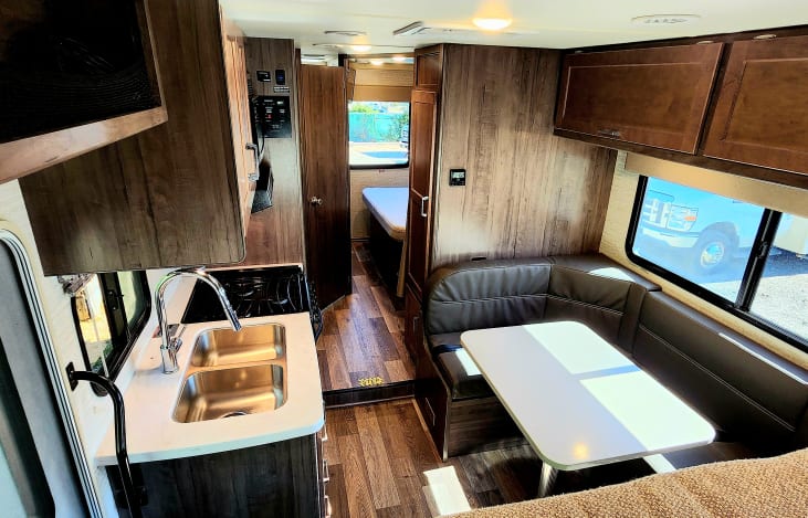 Living area with comfy dinette table that also turns into a bed.