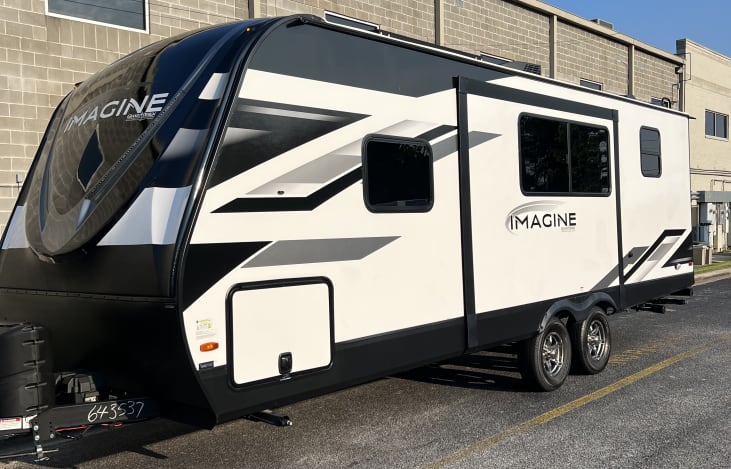 Exterior with storage compartment. 4 camping chairs, collapsible table and trash can provided.