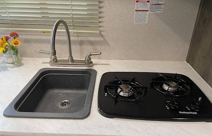Good size sink & a generous two burner range.