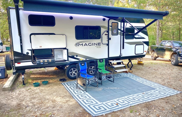 Your Adaventure Camper has exterior LED lighting, a large awning, convenient outdoor storage compartments, a super-capable 22-inch Blackstone style griddle, and an outdoor fridge.