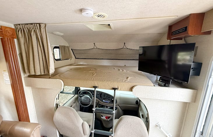 Oversized double bed with swivel smart TV