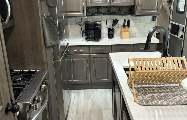 Keurig Duo, new knife block set, plenty of kitchen utensils, and a bamboo drying rack for dishes.