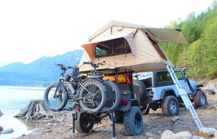 paddleboards and kayaks fit nicely below tent. Ebikes available for adventure packages at an additional cost.