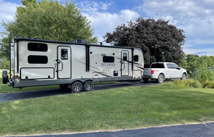 2023 Rockwood Ultra Lite Bunkhouse with exterior kitchen, exterior shower, double awnings, exterior lighting and sound system, and ample storage.