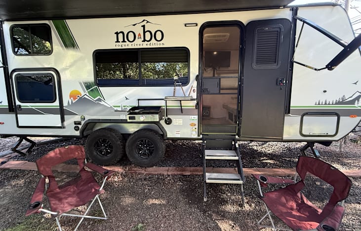 Main ouside awning setup with griddle and chairs.