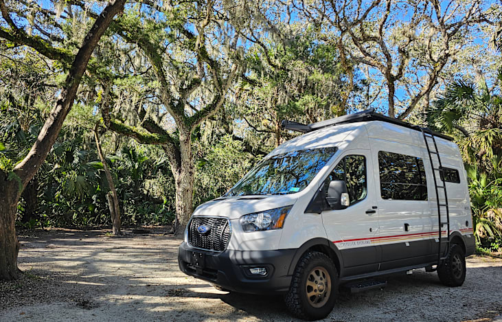 🚐 Your Adventure Begins Here—A Camper Van, A Campsite, A Story Unfolding –Tucked beneath the towering live oaks, the Storyteller awaits—a quiet invitation to slow down  and embrace the journey ahead.