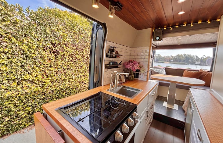 Fully stocked kitchen: sink, gas stove, oven, microwave, and refrigerator