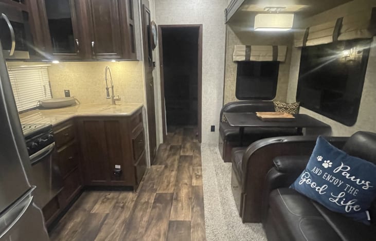 Interior and dining table set up folds into full size bed 
Couch pulls out to another queen