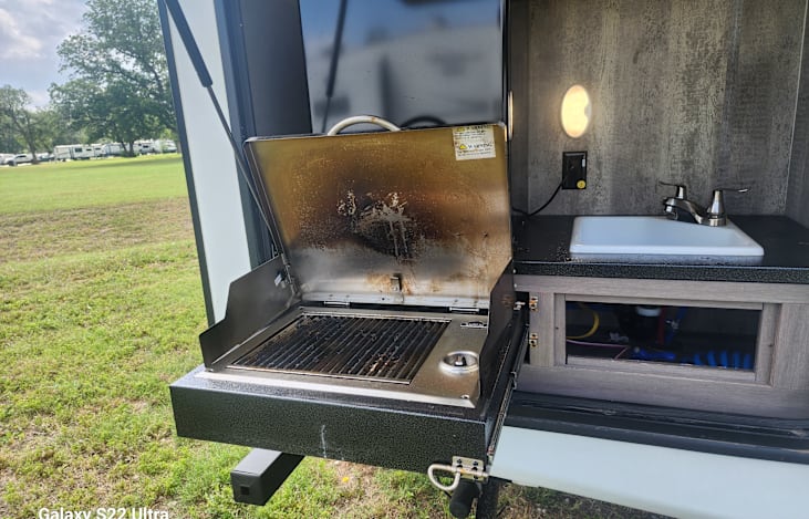 Enjoy the out door kitchen.  Complete with mini fridge gas grill, and sink.