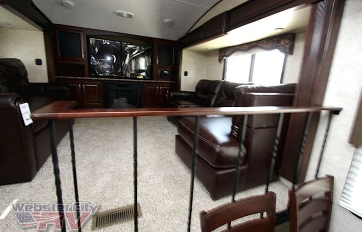 Stock Photo. Updated with wood Flooring. 
Couches will have covers. Their fake leather has rubbed off.