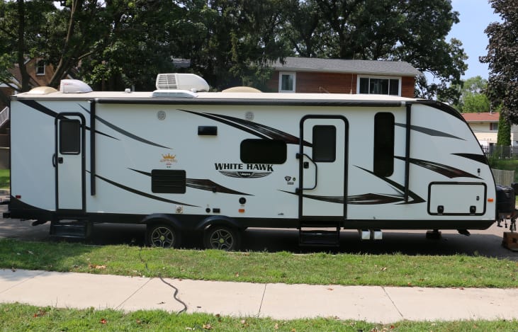 Passenger side of camper with main entry and bathroom entry